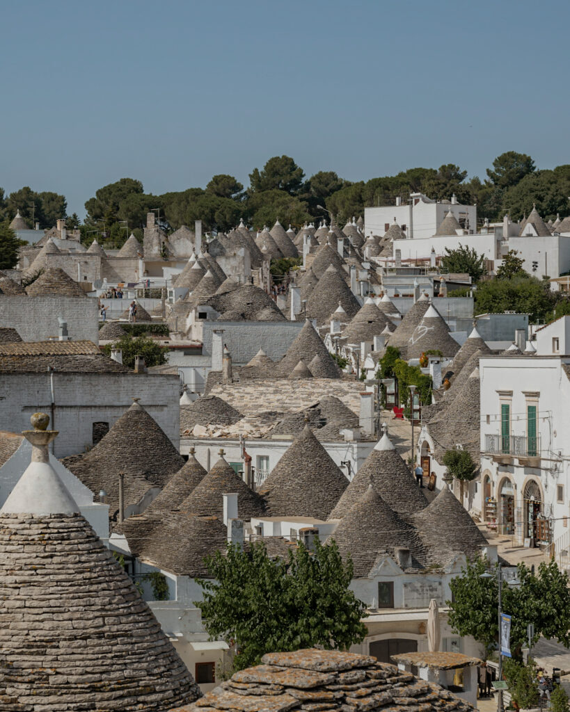 Puglia Itinerary: a high view of the iconic cone-shaped roofs of Alberobello.